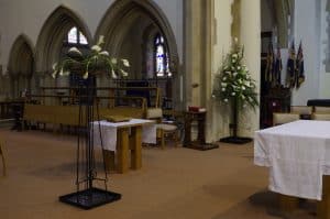 Easter 2021 nave altar view with paschal candle flowers